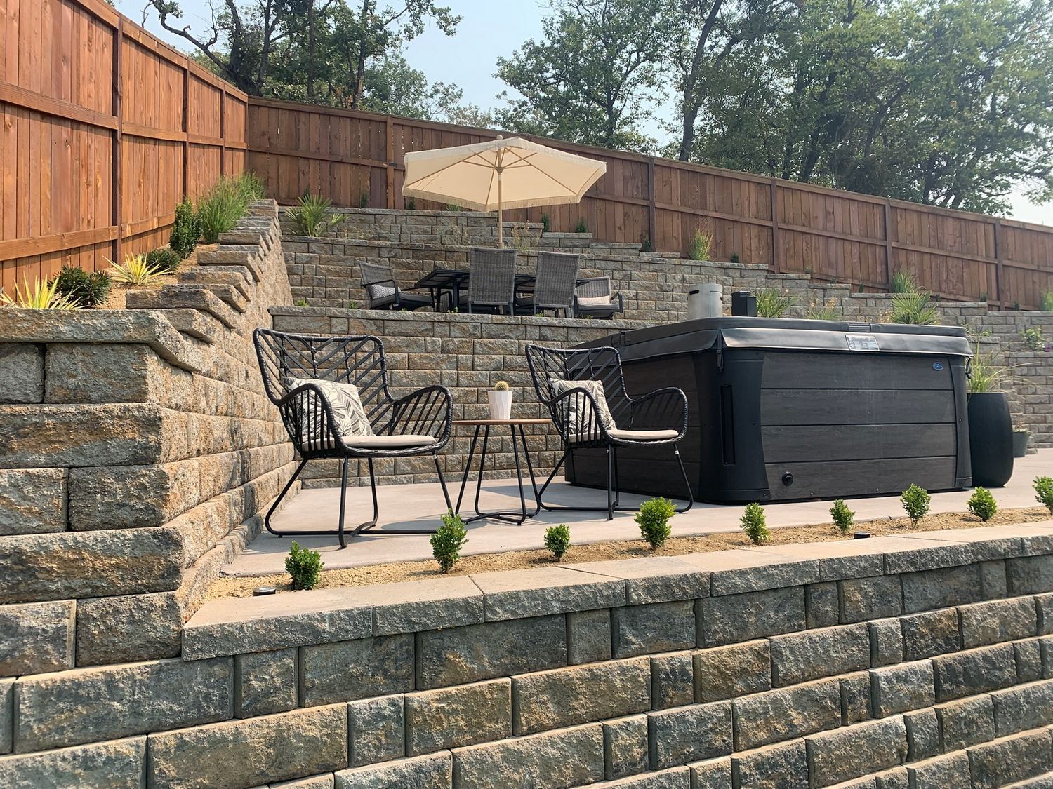 Terraced block retaining walls surrounding an outdoor living area