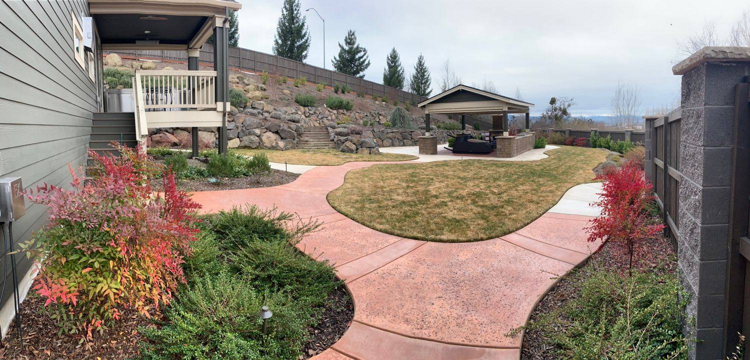 Curved hardscape walkway through a finished residential landscape