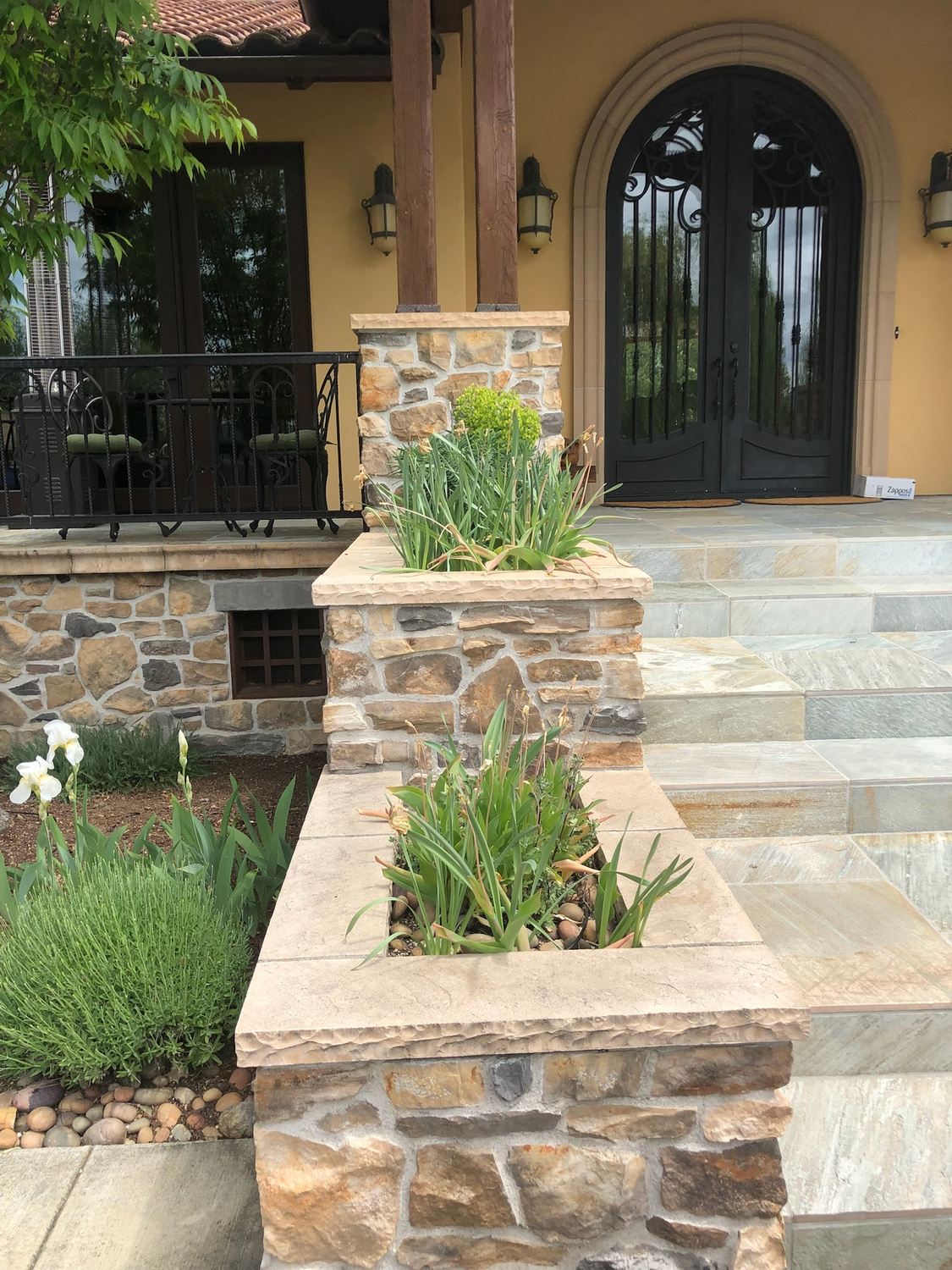Stone entry planters and steps with installed plants