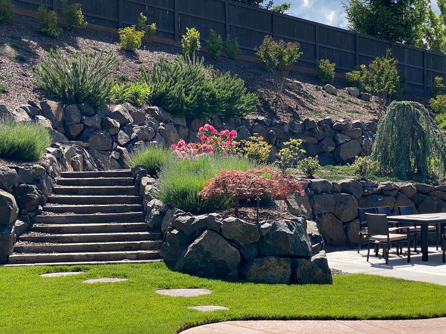 Stone steps through planted retaining-rock terraces