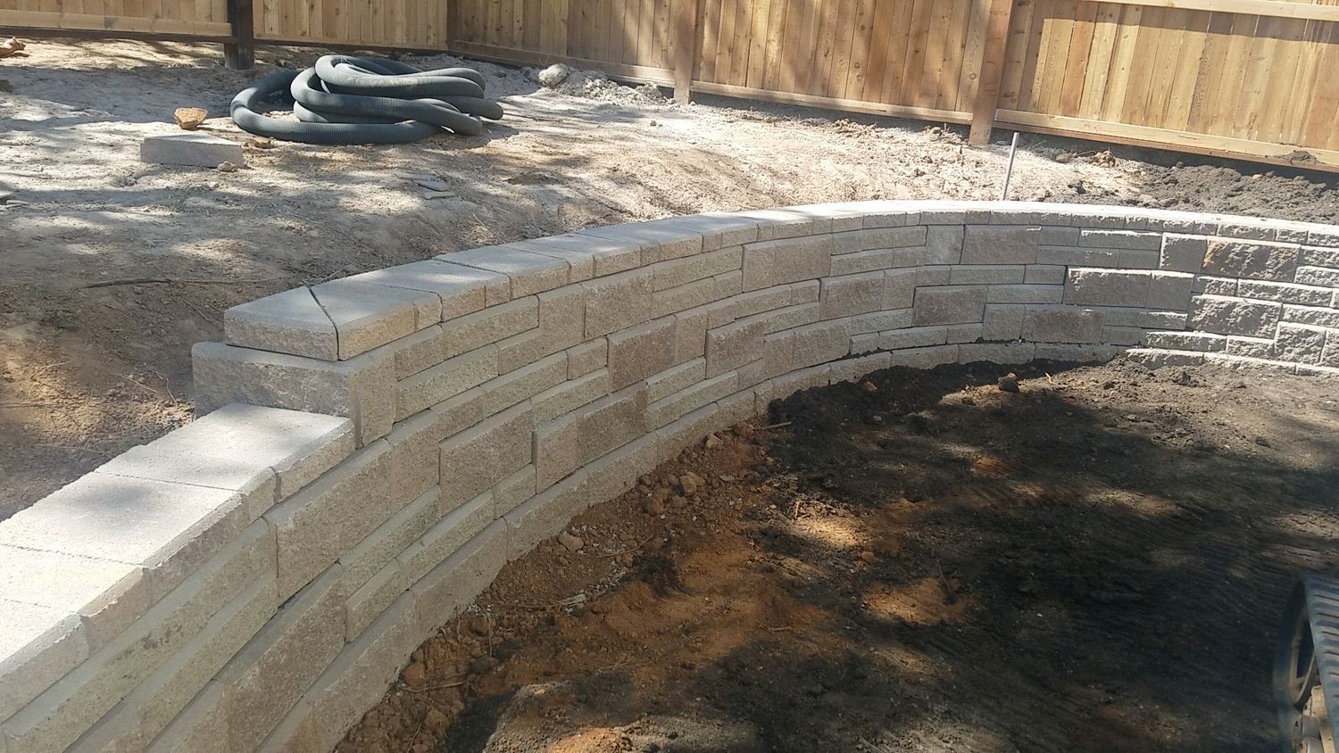 Curved block wall and steps during landscape construction